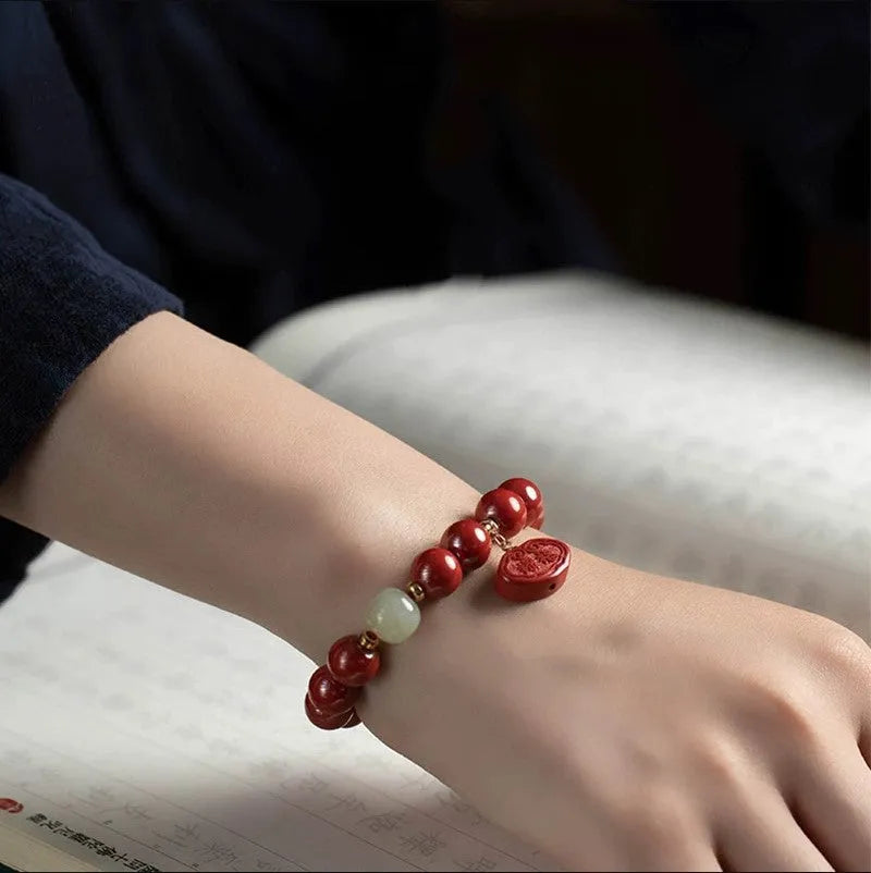 Natural cinnabar Emperor sandstone bracelet with traditional Ping An Fu Lu motifs