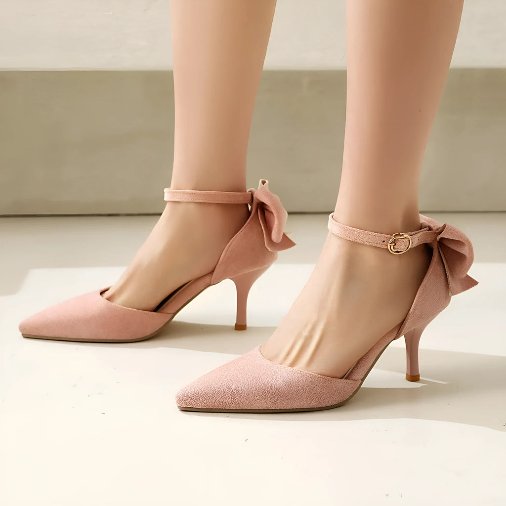 Black suede women's stiletto heels with a pointed toe and a decorative bowknot on the upper.
