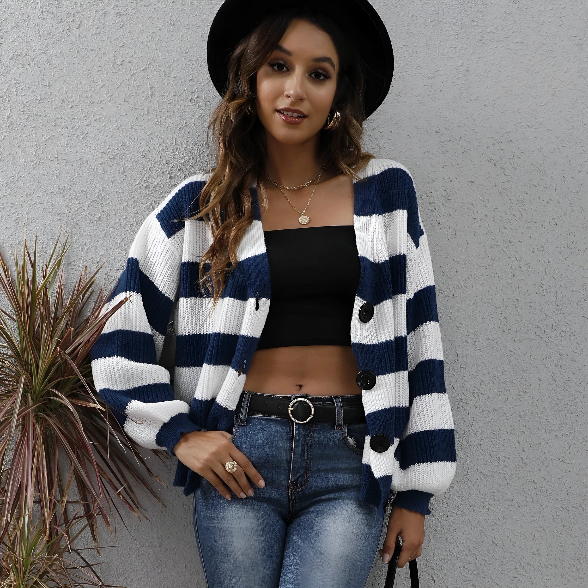 Women's striped cardigan sweater in deer plush fabric with button stitching.