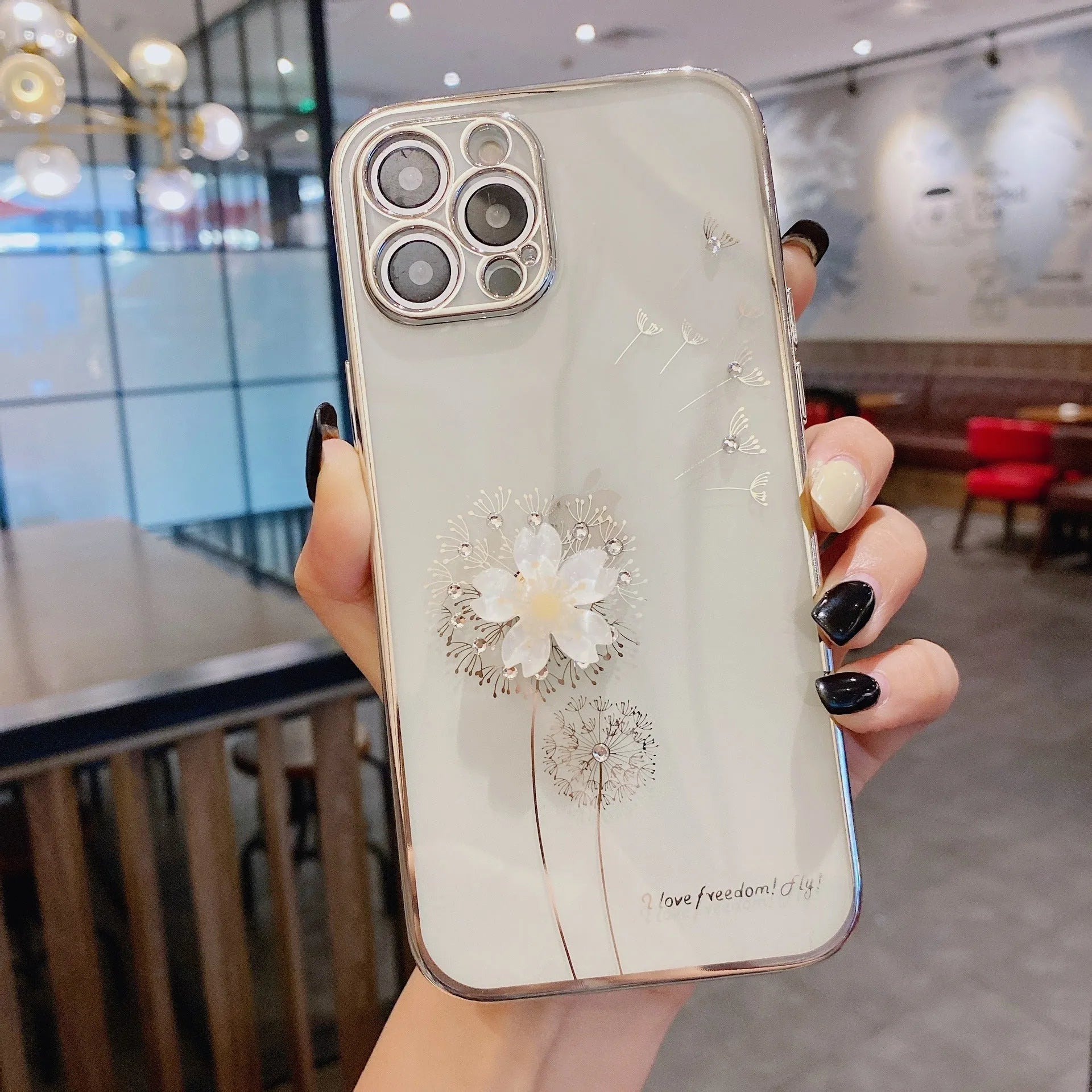 Green iPhone case with 3D floral design and extended kickstand on a table