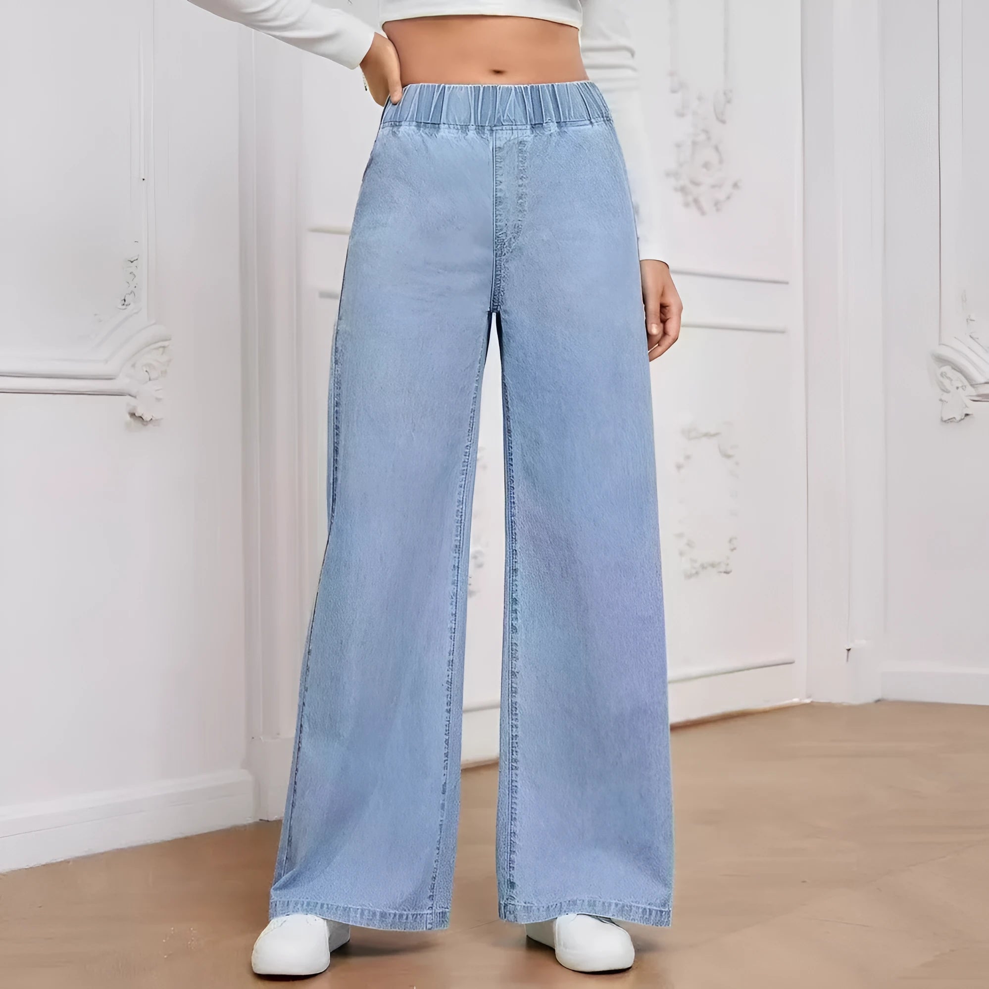 Light blue washed plus size women's wide-leg straight jeans on a mid-waist fit.