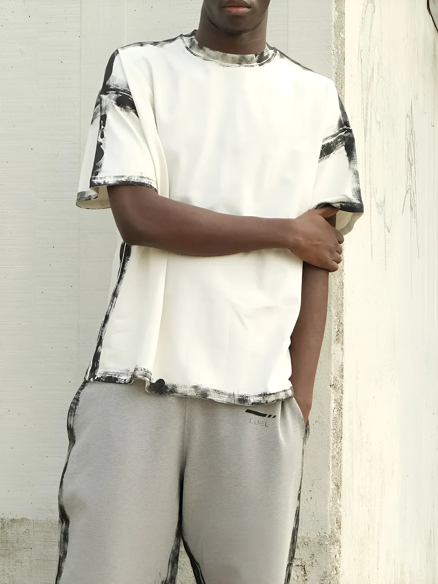 White casual short sleeve top with a draped design and printed pattern.