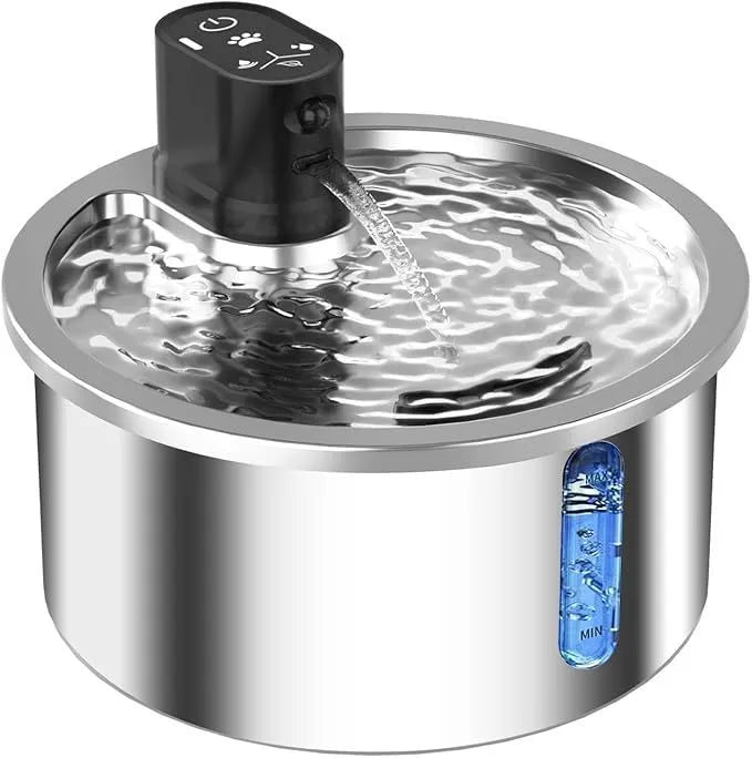 Stainless steel pet water fountain with a white heating base on a kitchen counter.