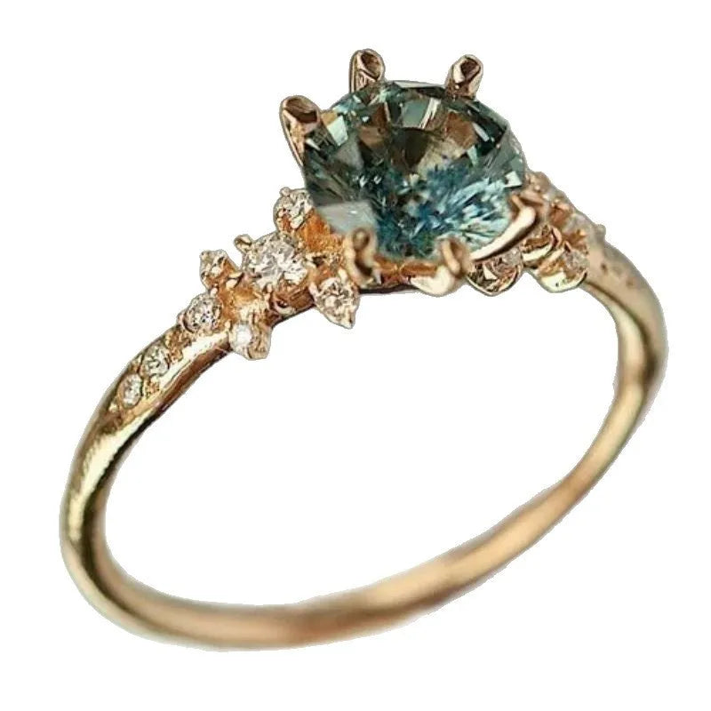 Gold plated geometric ring with claw-set zircon stones in a chamfered square design.