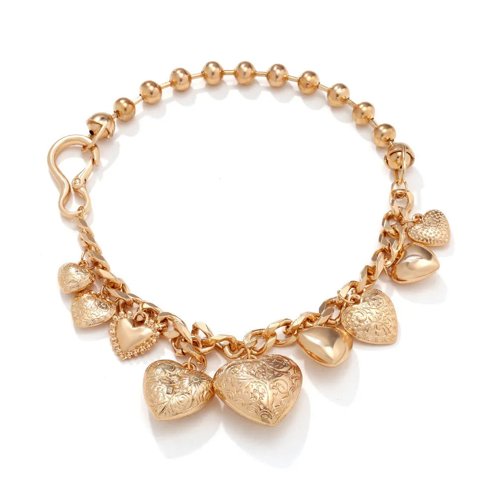 Gold exaggerated carved heart pendant necklace on model, showing adjustable metal chain.