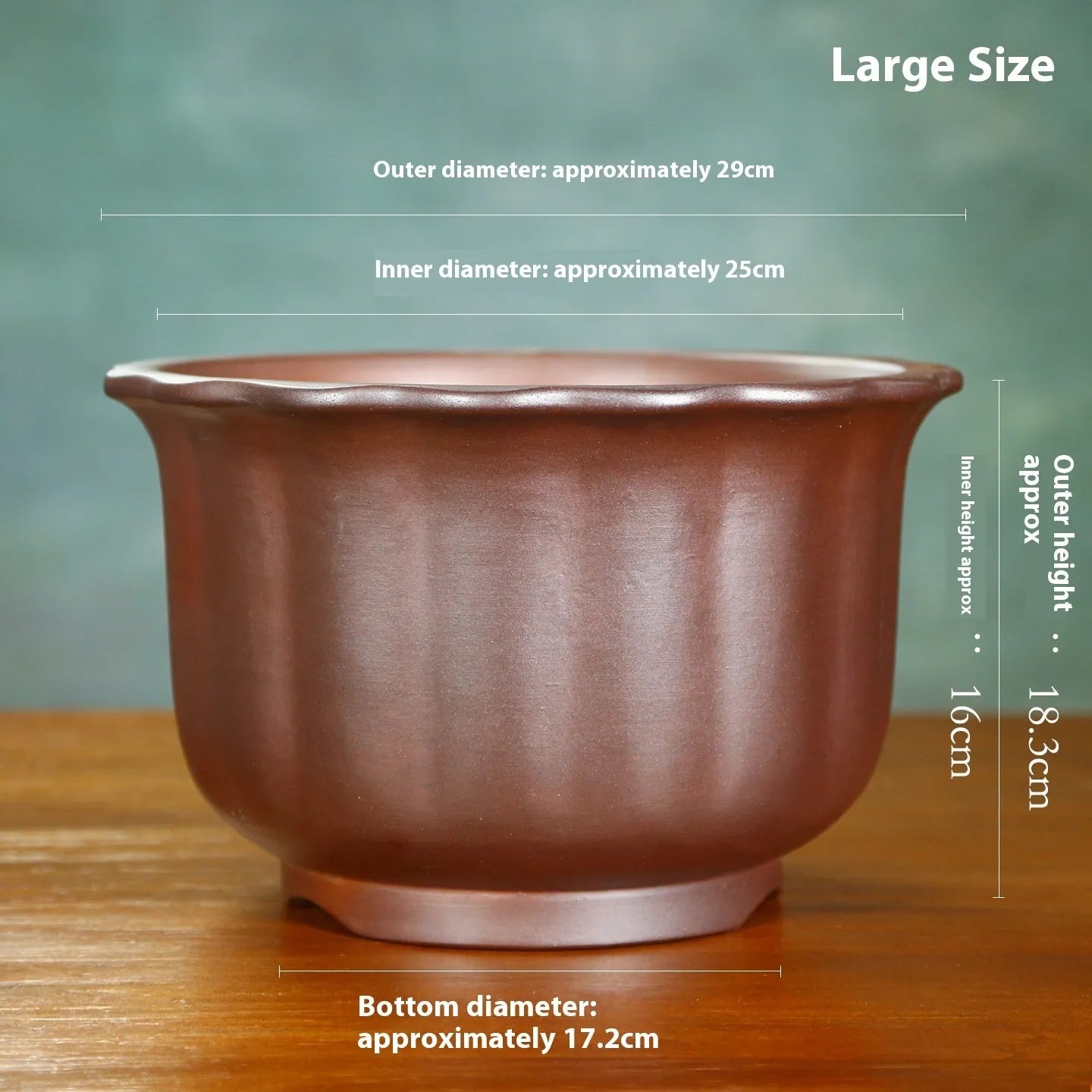 Antique carved ceramic flower pot with wood burning finish on a wooden table.