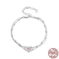 Women's sterling silver bracelet with a small heart-shaped pendant on an adjustable chain.