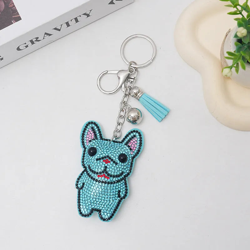 Close-up of a caramel-coloured alloy dog keychain with sparkling clear rhinestones.