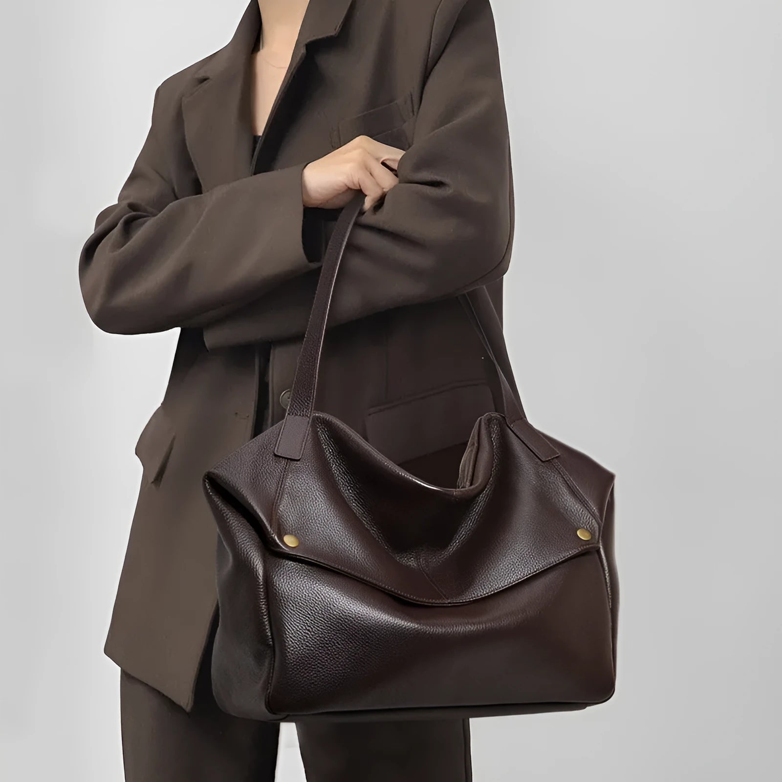 Brown genuine leather women's commuter shoulder bag with a horizontal square shape.