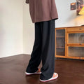Men's jacquard rhombus draped pants in black, long straight-leg polyester blend trousers with non-ironing finish.