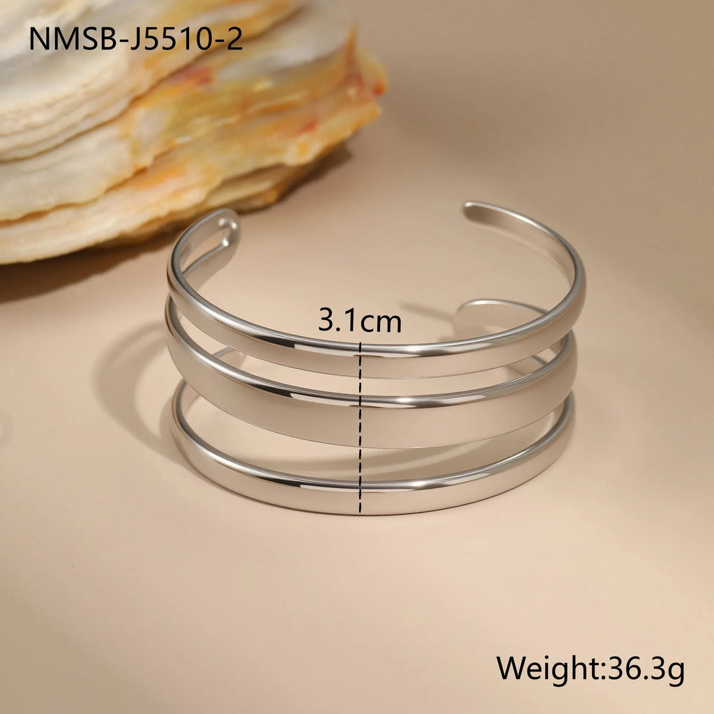 Geometric line design stainless steel bracelet with simple opening clasp, shown in gold and steel colour options.