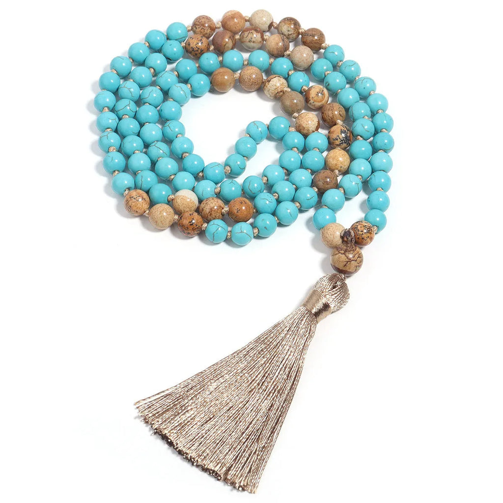 Handmade blue pine turquoise stone mala necklace with ball beads on a white background.