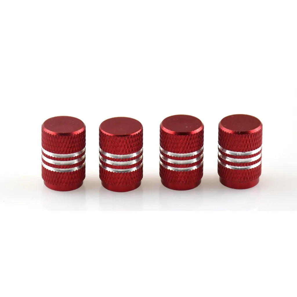 Assortment of aluminium alloy car tyre valve caps in ten different colours on a grey background.