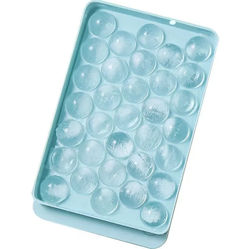 Blue silicone ice cube tray with lid showing 33 round grids for making ice balls.