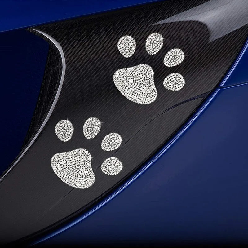 Close-up of a white diamond glass car sticker with a butterfly and bear paw design.