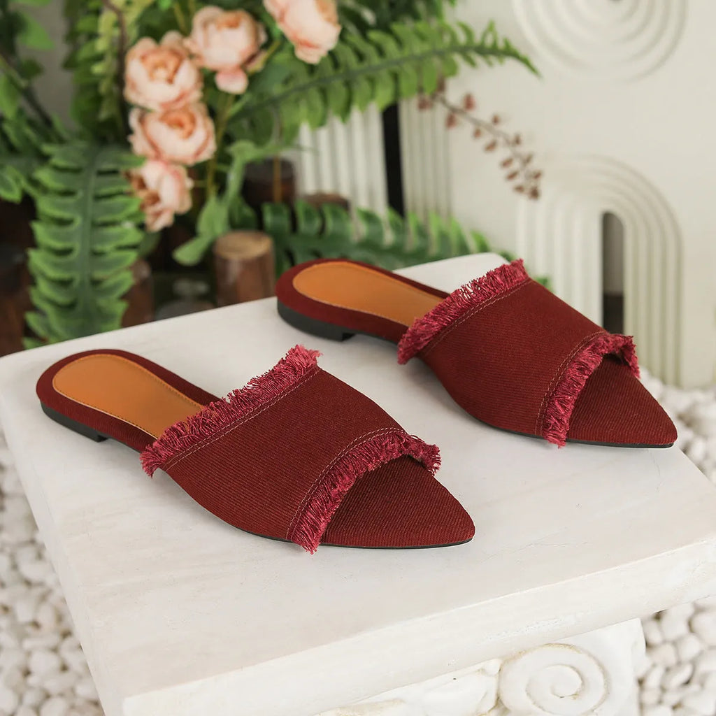 Women's denim flat slippers with tassel decoration in various colours showing leather lining and PVC soles