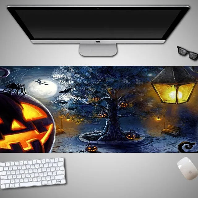 Large Halloween patterned gaming mouse pad on a desk showing non-slip rubber base and extra-long design.