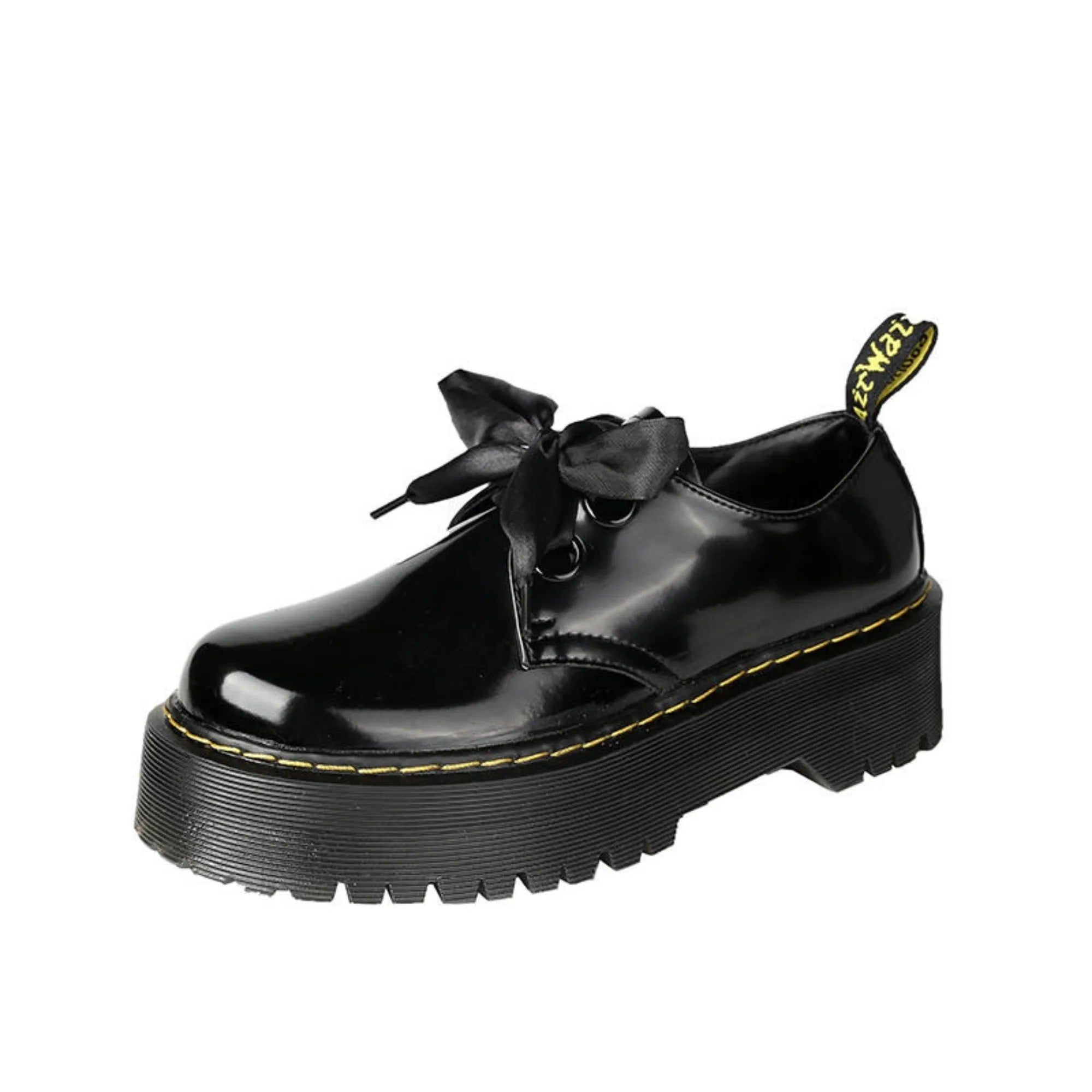 Women's black leather shoes with a thick sole, cross straps, and ribbon laces laid flat.