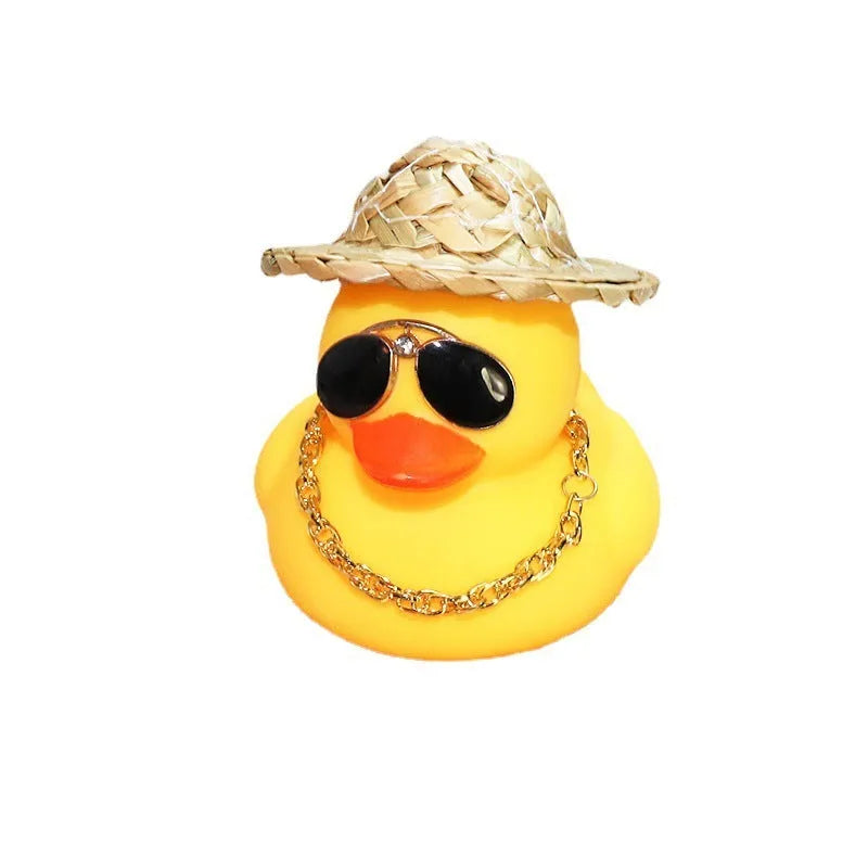Straw hat yellow duck car ornament with adhesive gel and miniature sunglasses accessory on car dashboard