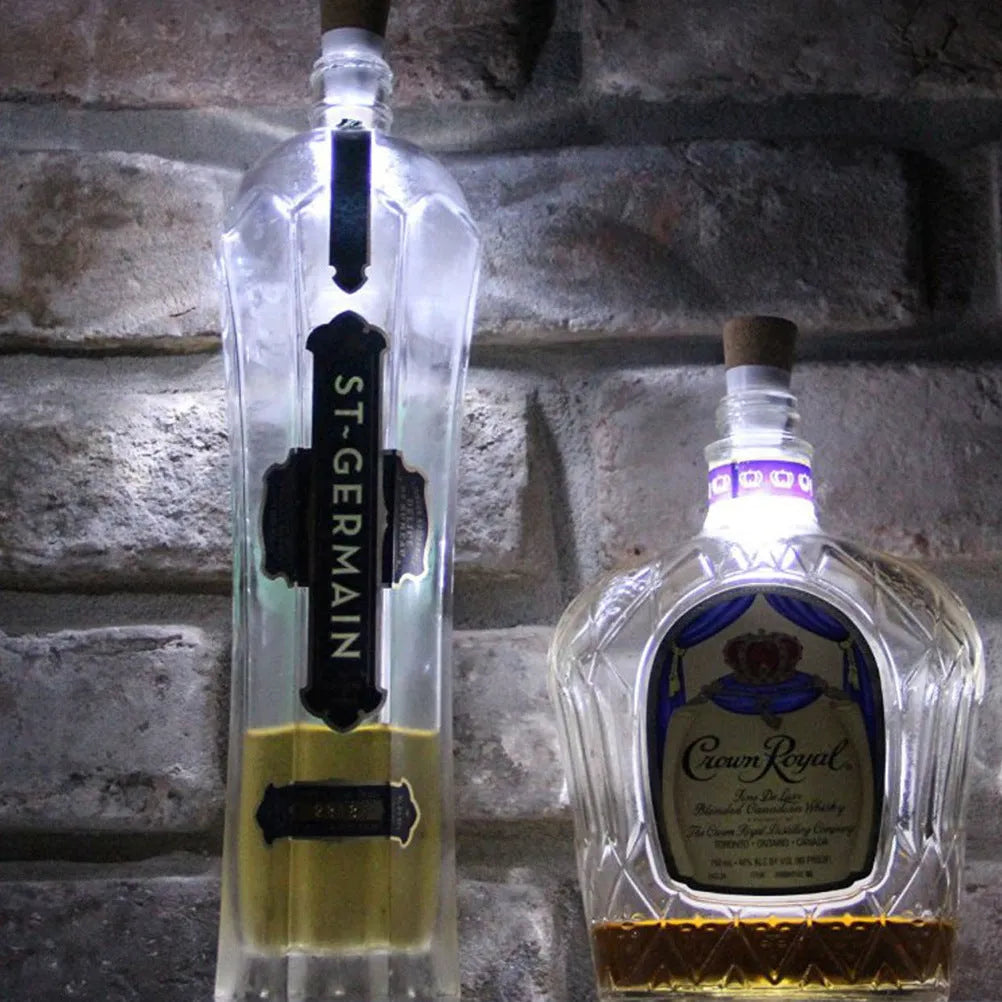White plastic LED rechargeable bottle cap cork light with 15 beads, shown next to a wine bottle for scale.
