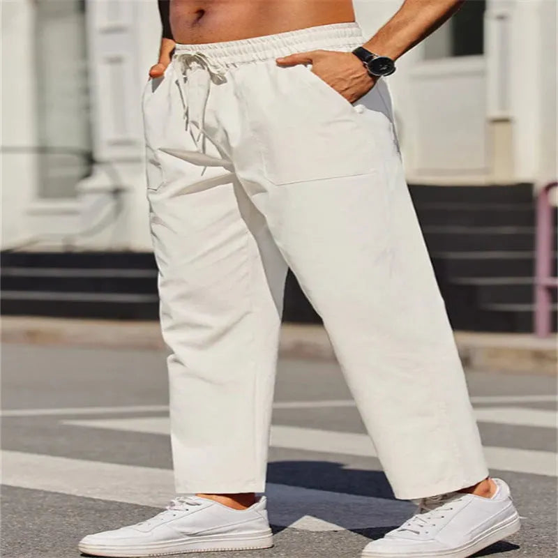 Men's straight-leg linen casual trousers with an elasticated waist in a solid colour.