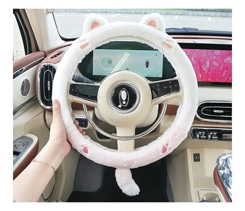 Plush steering wheel cover with embroidered bear design, shown fitted on a car steering wheel.