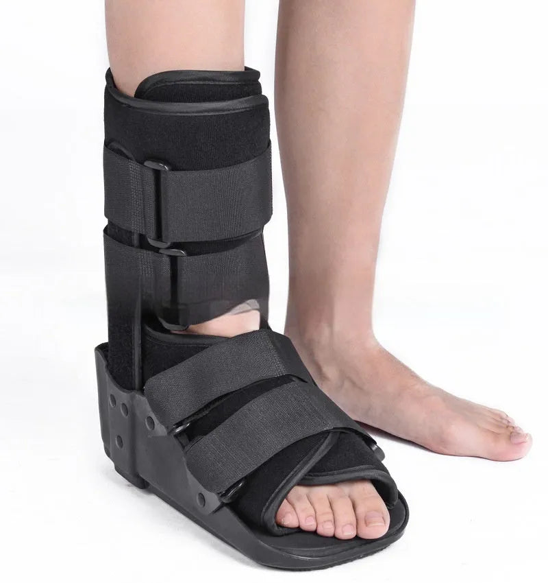 Grey and black Achilles tendon rehabilitation boot with adjustable straps and rocker sole for walking support.