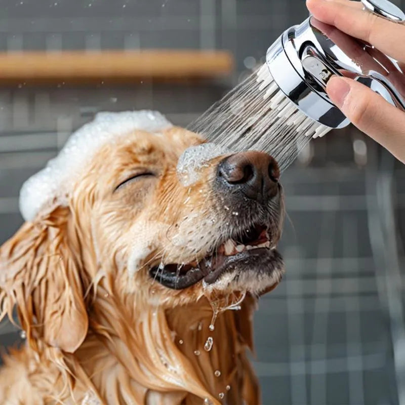 Silver coloured dog shower attachment with ergonomic grip and soft silicone comb teeth.