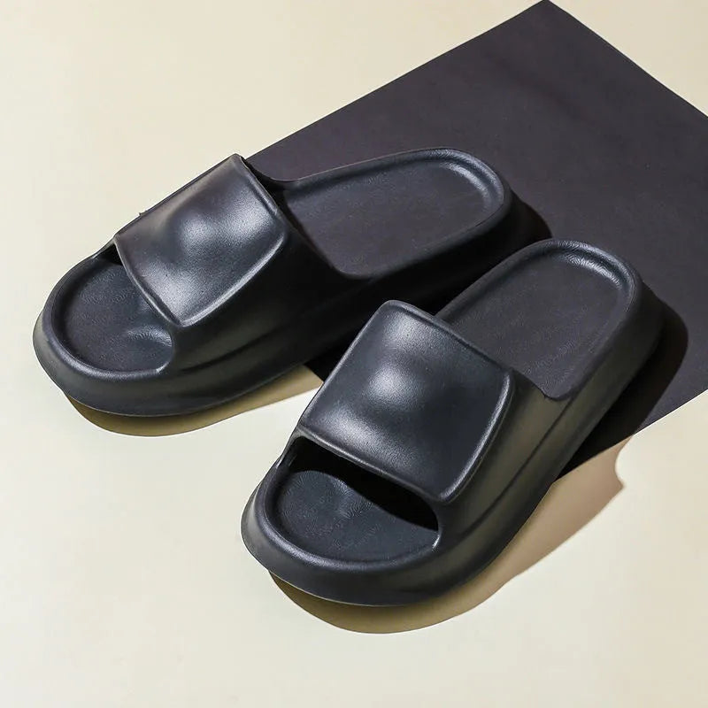 A pair of thick-soled EVA flip-flop slippers on a bathroom floor, showcasing non-slip tread and available colour options.