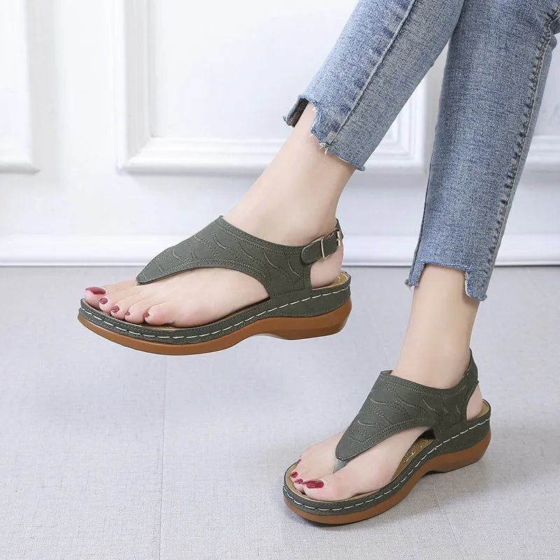 Women's black casual wedge heel flip flop sandals with an adjustable buckle strap.