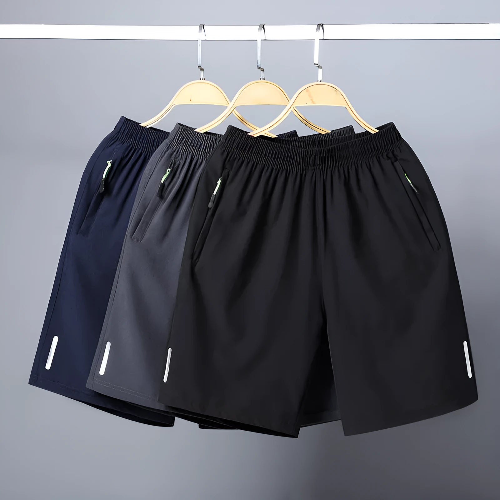 Men's polyester solid colour beach casual sports shorts with zippered pocket in black, gray, and blue