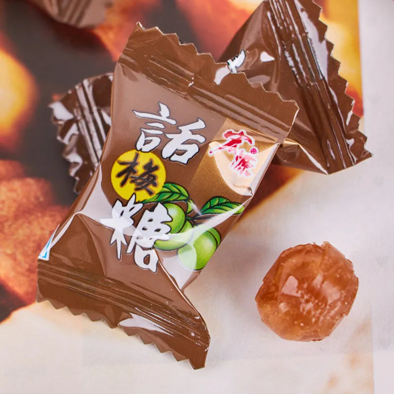 Assortment of Chinese fruit hard candies: plum sugar, guava and tangerine peel flavours in separate packets.