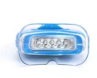 Transparent silicone denture model on a clean surface with natural light showing clear tooth structure