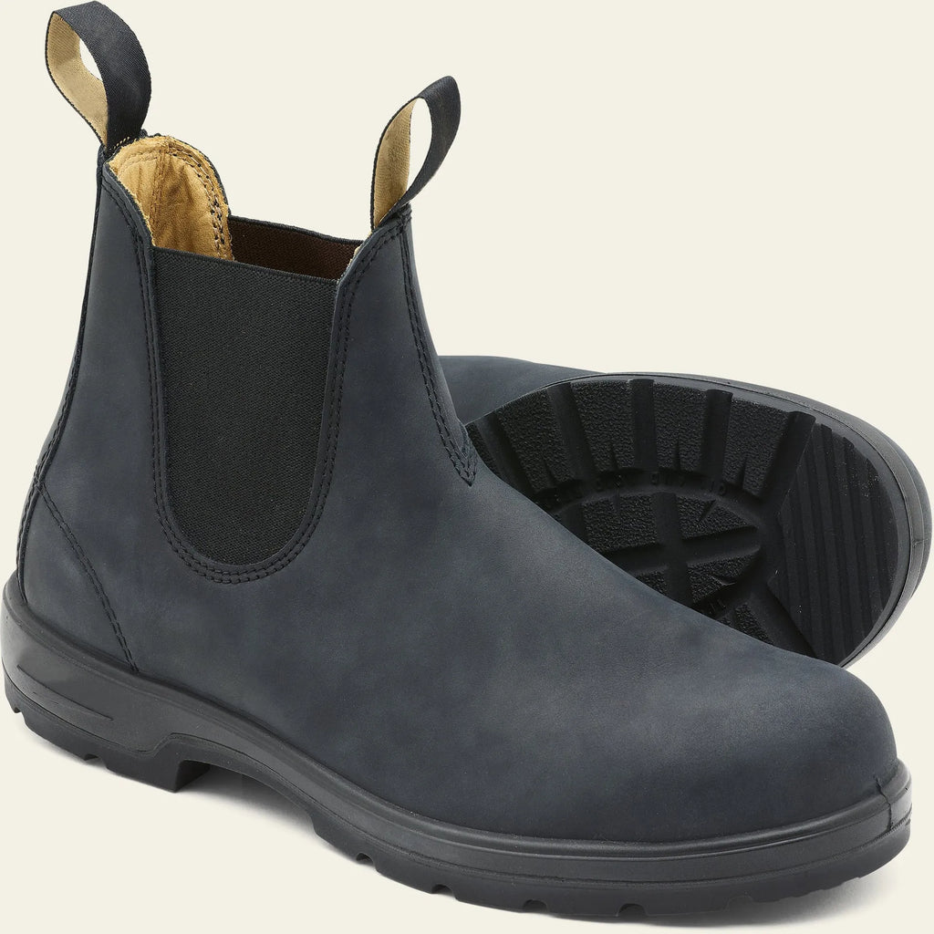 Vintage brown unisex Chelsea boot with frosted PU upper and car suture detailing on a wooden floor.