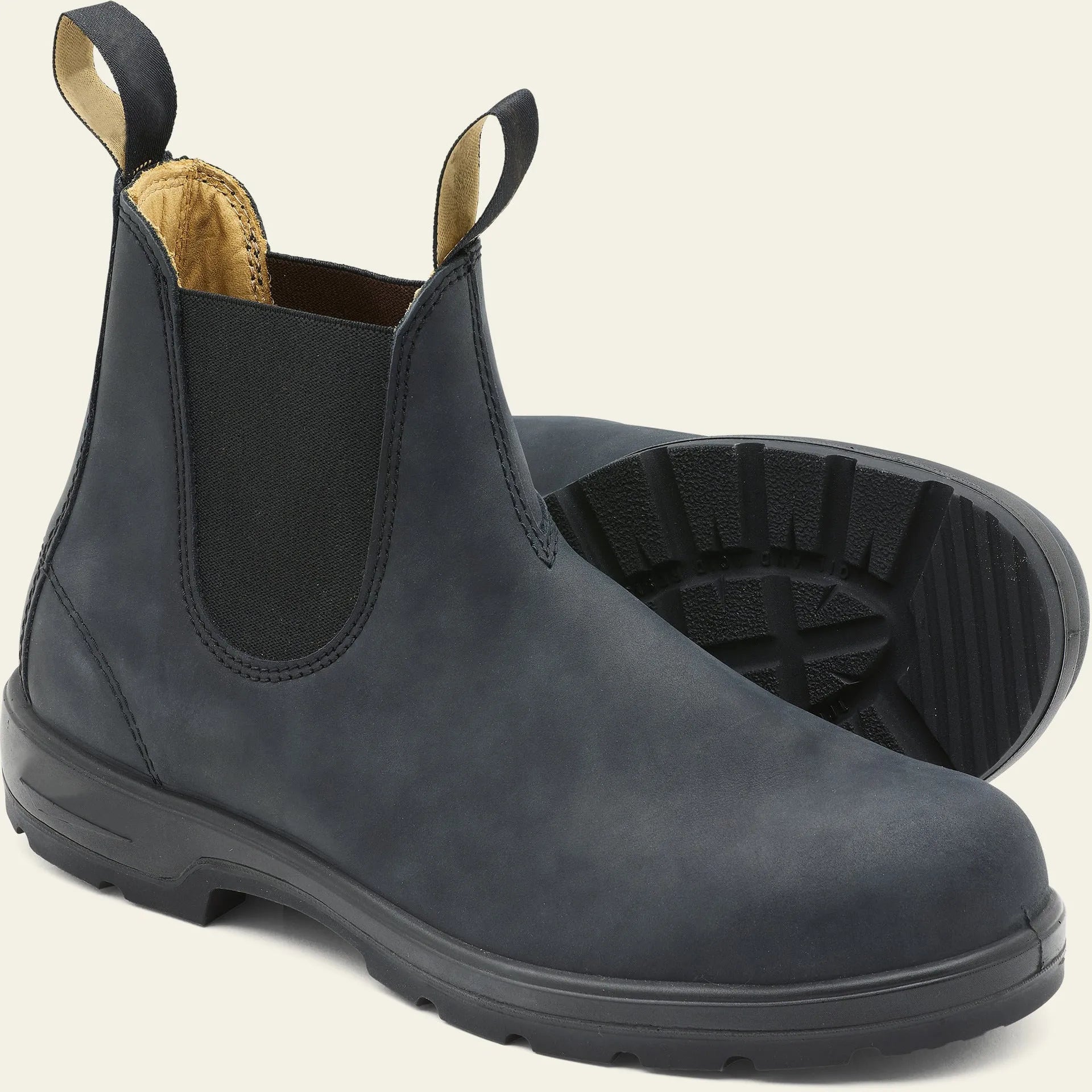 Vintage brown unisex Chelsea boot with frosted PU upper and car suture detailing on a wooden floor.
