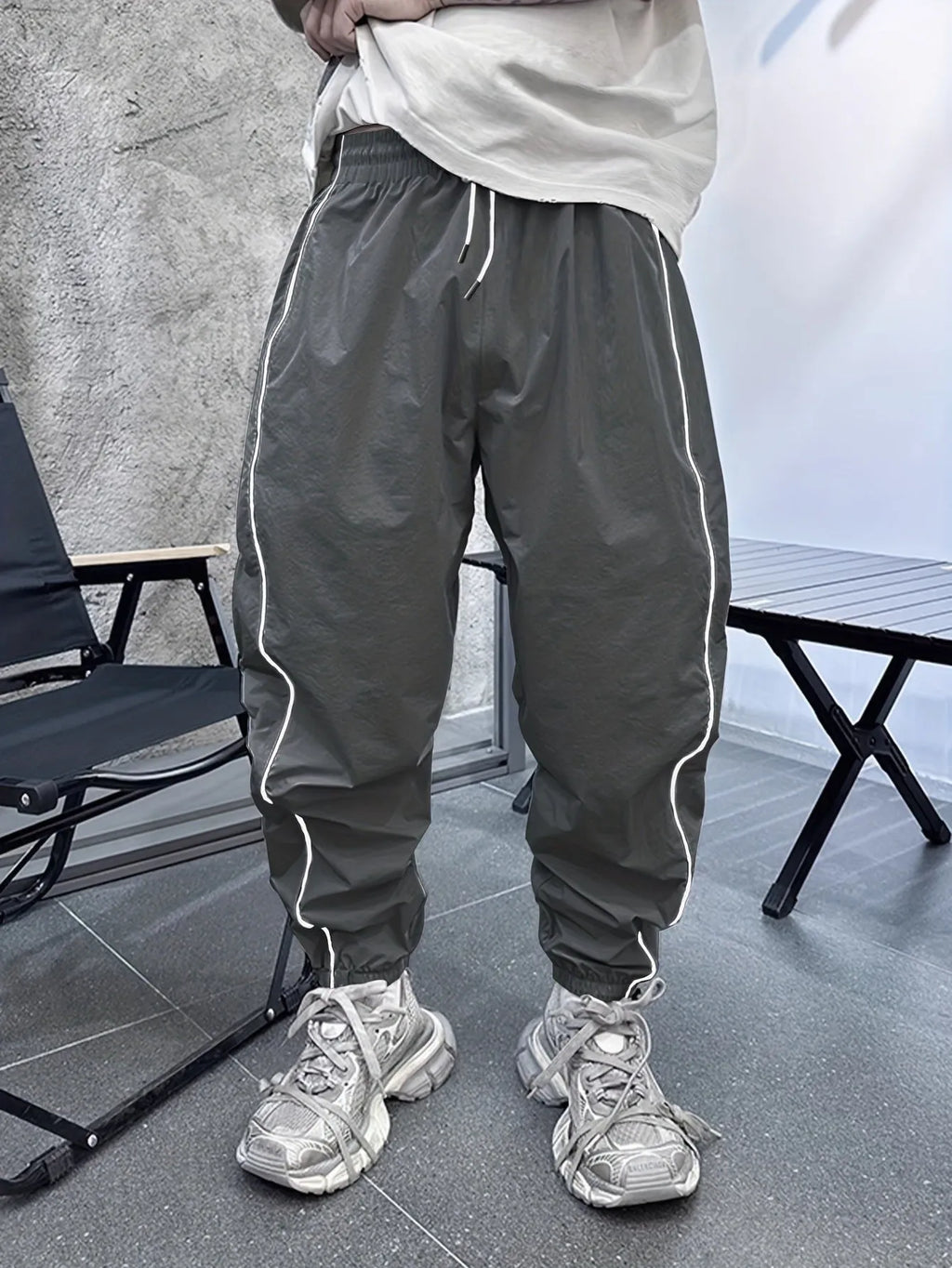 Men's blue bamboo fibre casual sports trousers with cropped length and loose fit on a hanger.
