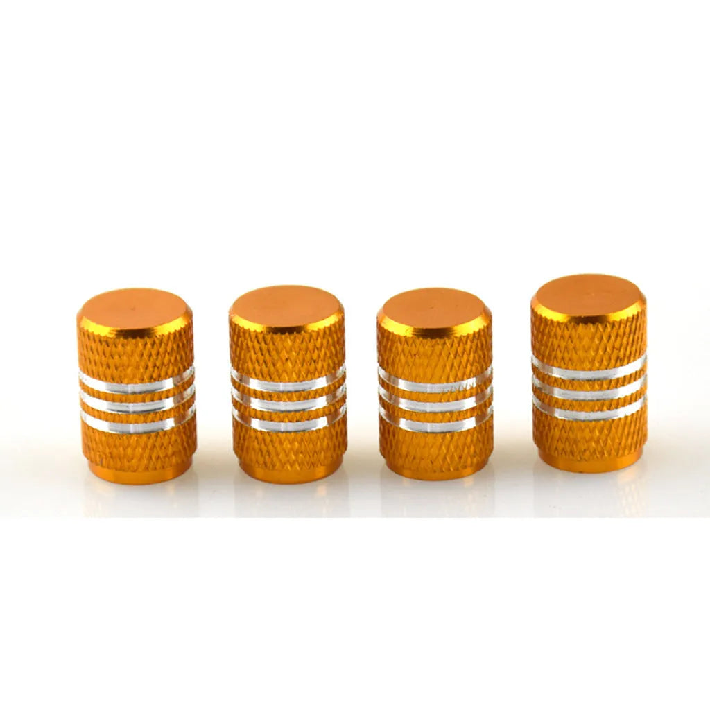 Assortment of aluminium alloy car tyre valve caps in ten different colours on a grey background.