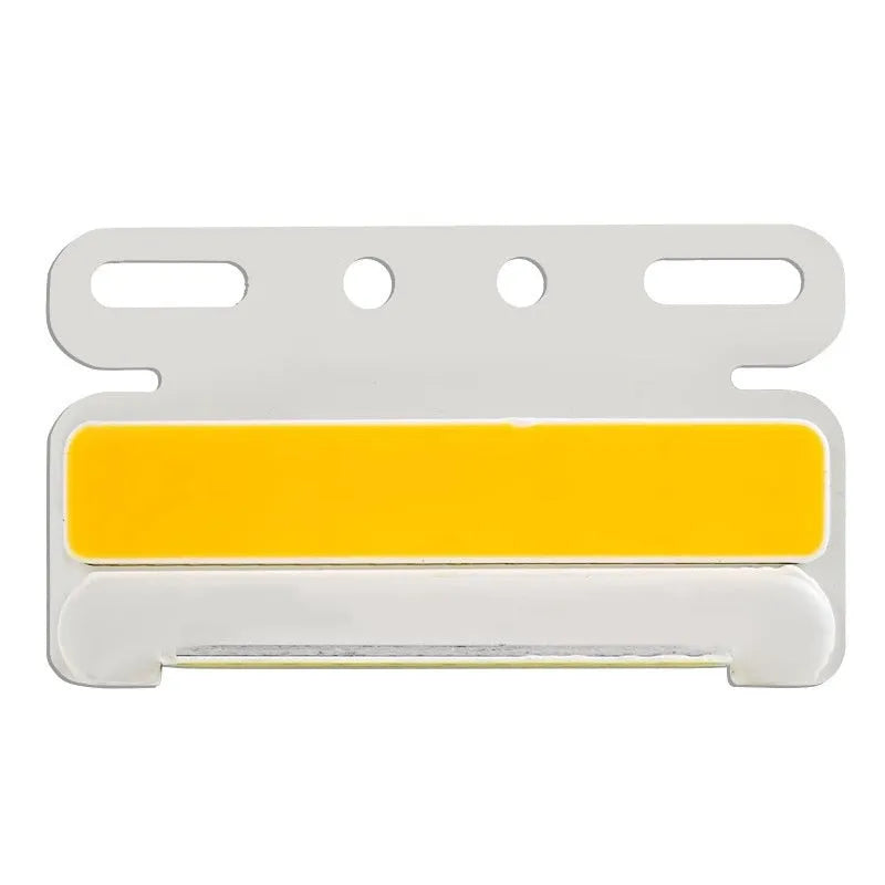 Aluminium alloy COB LED truck side light projecting bright white light onto ground next to tyre.