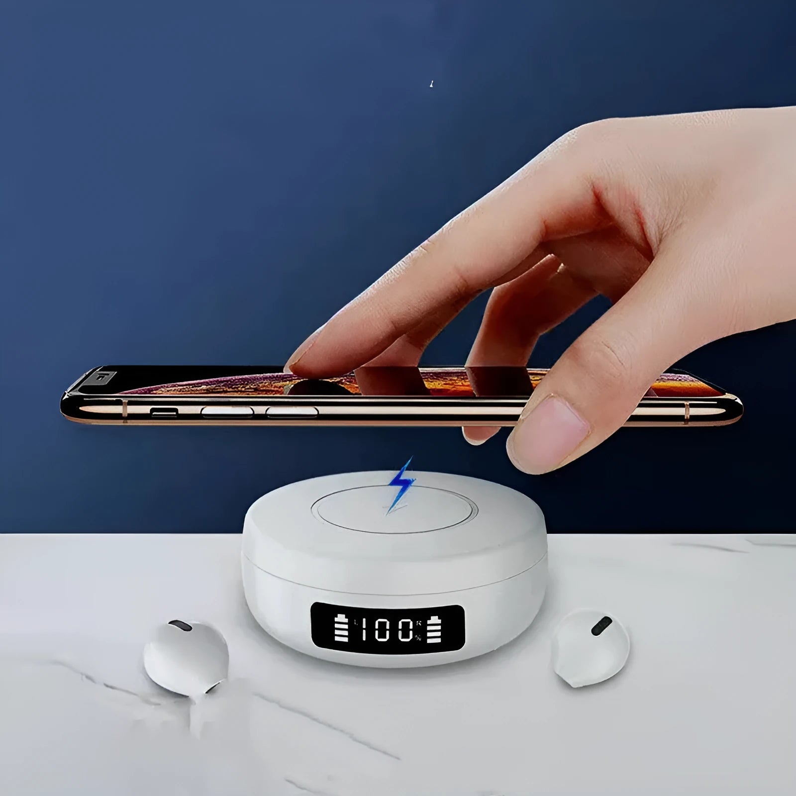 Mini black semi-in-ear wireless headphones with their compact wireless charging case on a table.