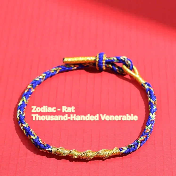 Close-up of an adjustable eight-strand woven hand strap in a zodiac-themed colour on a wrist.
