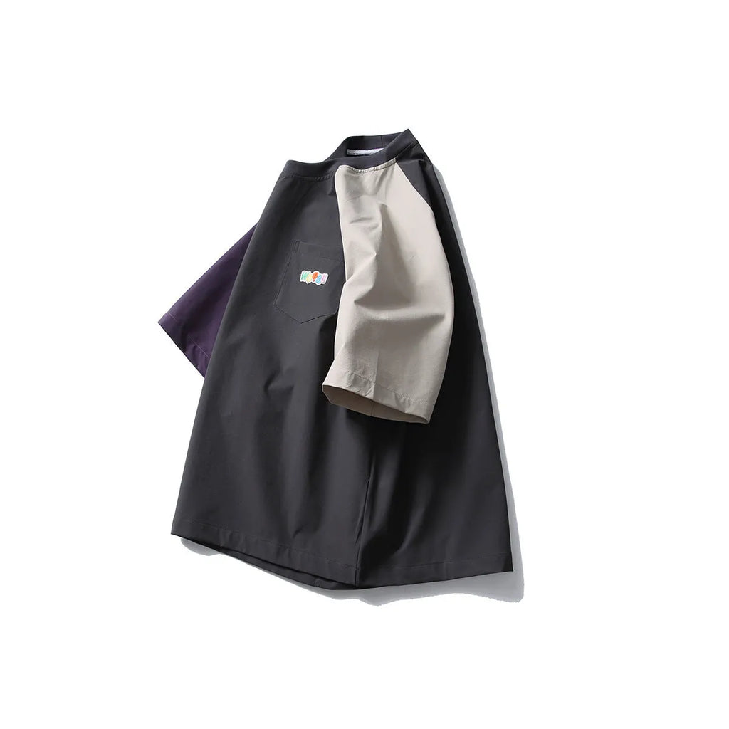 Dark grey men's t-shirt with contrast colour panels and raglan sleeves laid flat.