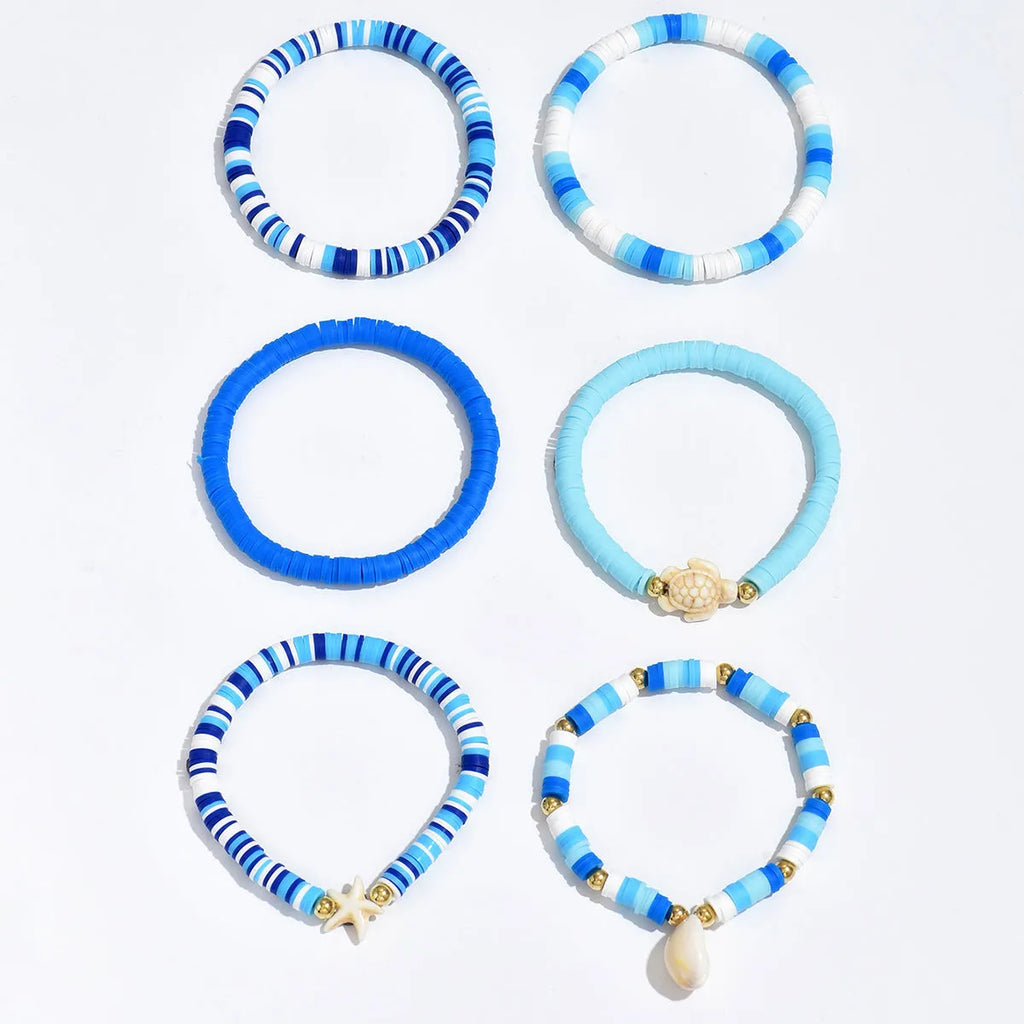 Set of six handmade bohemian polymer clay bracelets with shell and geometric designs in S3162 colour.