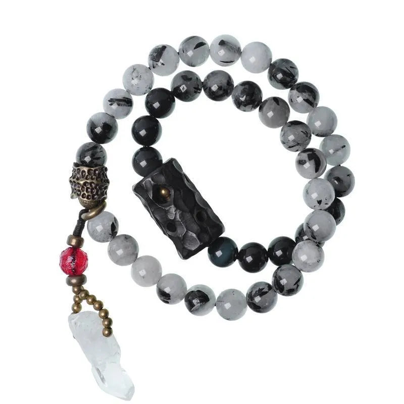 Men's ethnic black hair bracelet with white crystal tassel showing bending and lacing details