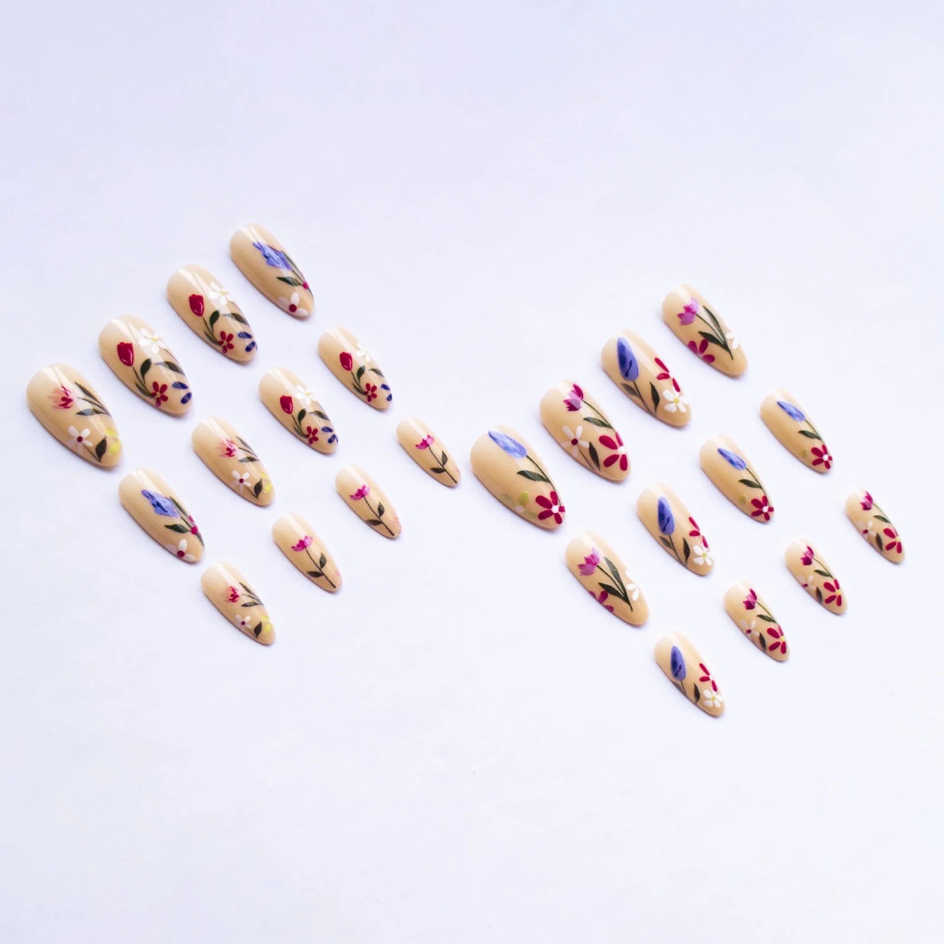Almond-shaped removable nail art set featuring rose, tulip, and flower patterns on a hand.