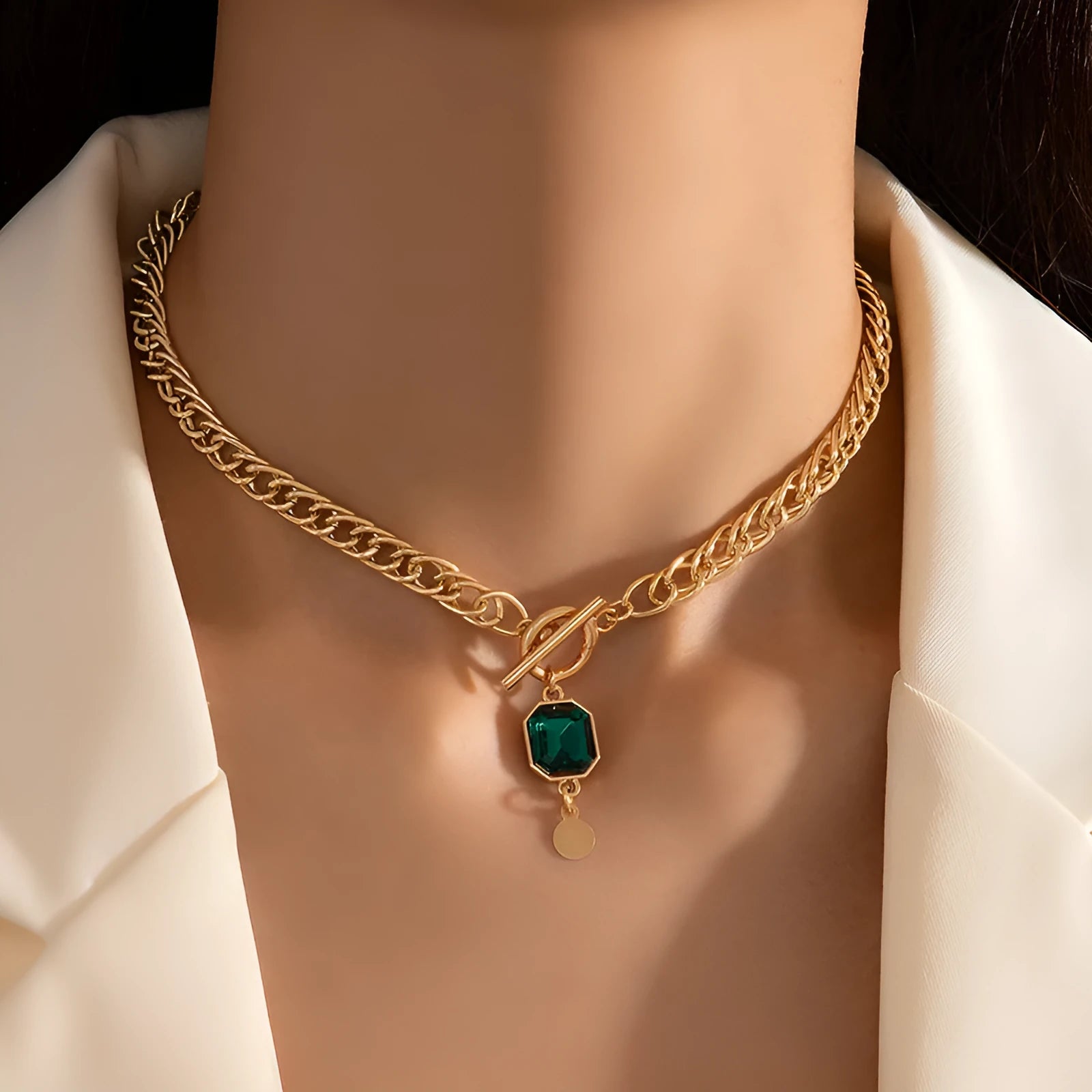 Gold electroplated titanium steel necklace with geometric pendant and emerald zircon stone