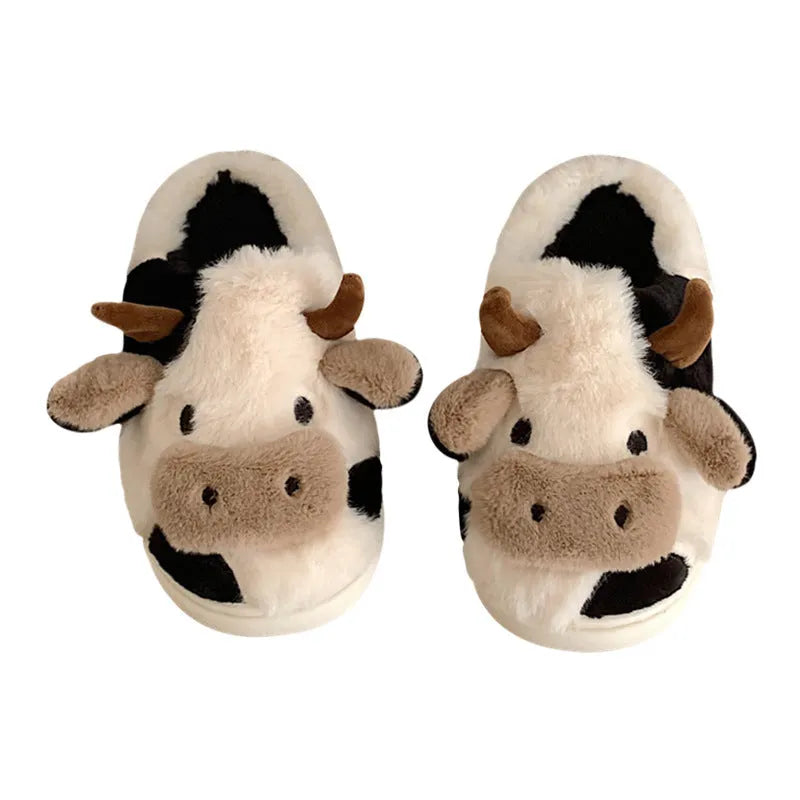 White women's cow slippers with fluffy faux fur, cartoon face, and textured non-slip sole.