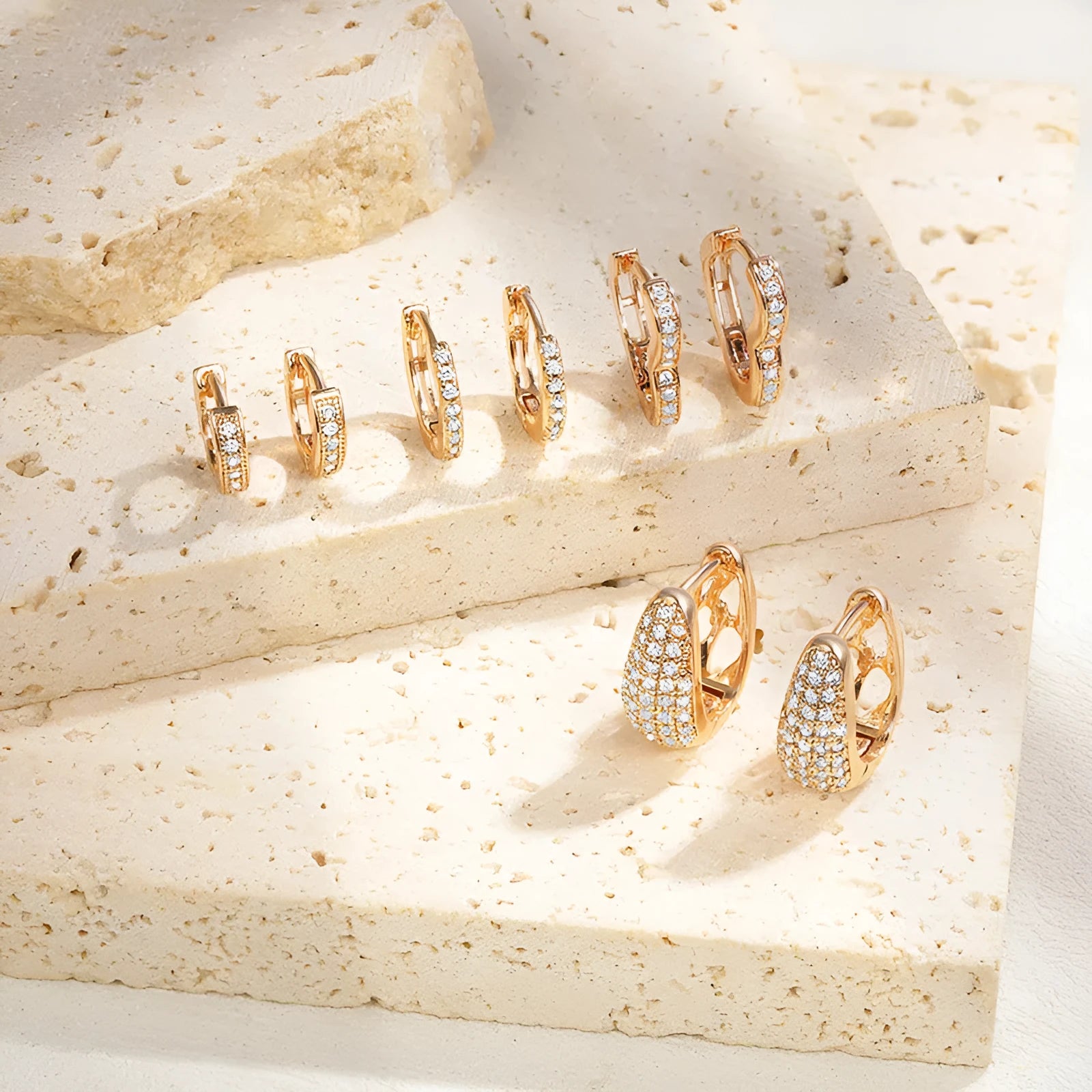 Gold plated heart shape clip earrings with cubic zirconia stones, shown in champagne gold tone colour