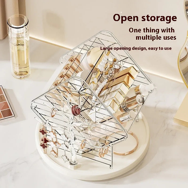 Rotating clear plastic cosmetics organiser box with multiple tiers on a wooden dresser.