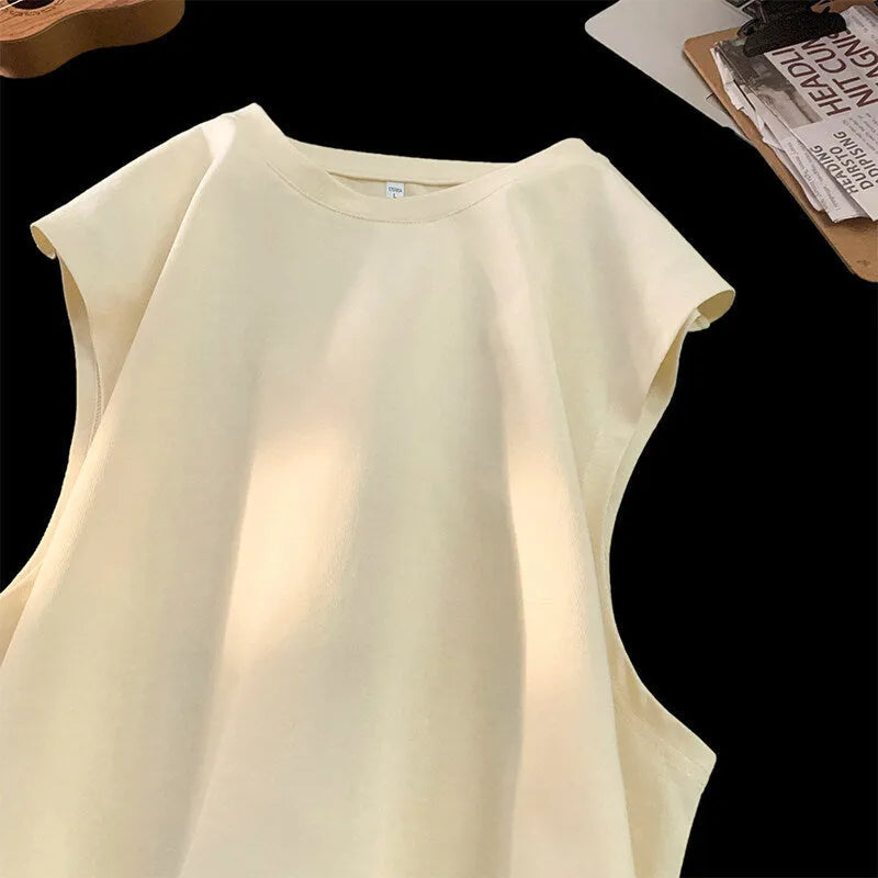 Men's loose solid colour cotton tank top on a hanger, showing straight hem and sleeveless design.