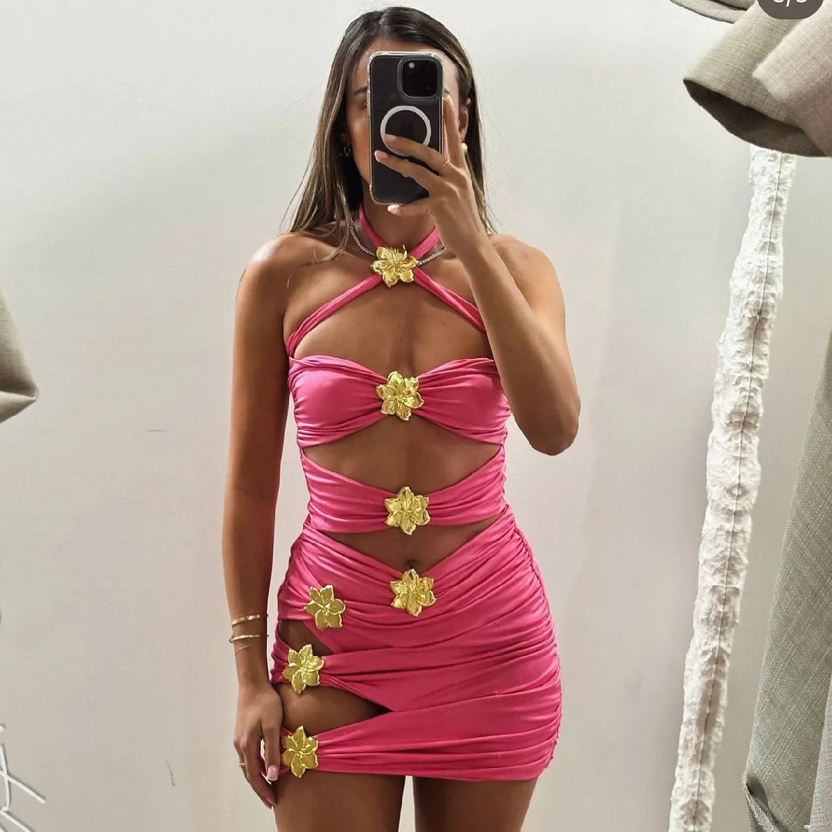 Women's solid colour one-piece swimsuit with hollow-out tube top and matching short skirt on hanger.